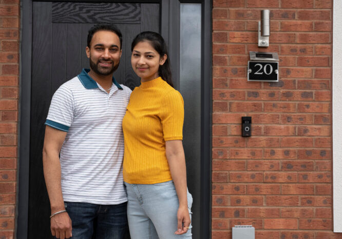 Portrait of couple standing on front porch