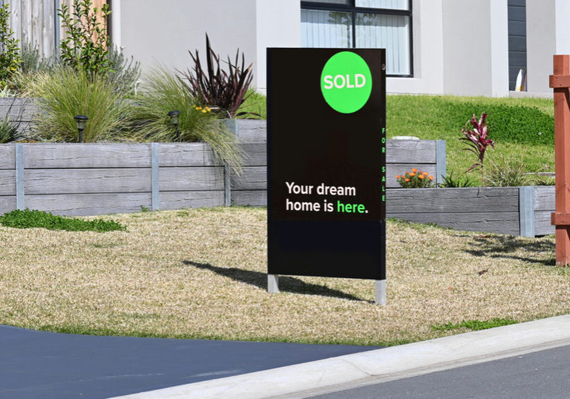 Home for sale sign with sold written on the side